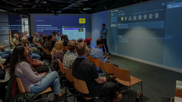 Wide view of the immersive zone with the ScoutCast app and the agent pipeline displayed across the wraparound screens as the audience looks on